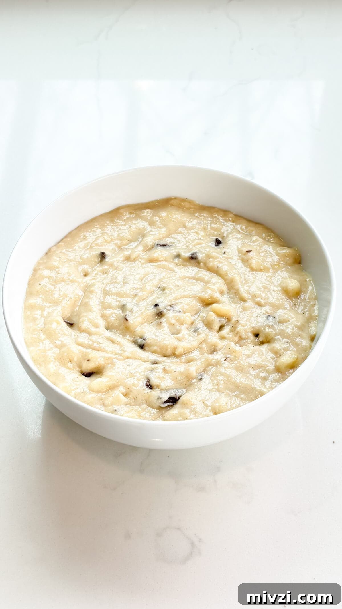 Chocolate Chunk Banana Bread Recipe with Gooey Chocolate Chunks 8 Batter mixed in a bowl.