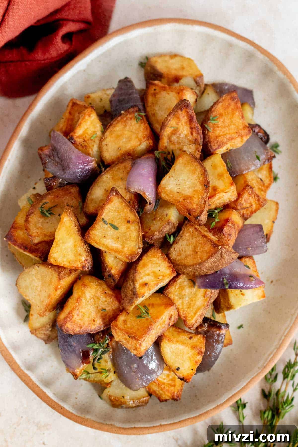 Overhead view of a plate of air fryer potatoes and onions.