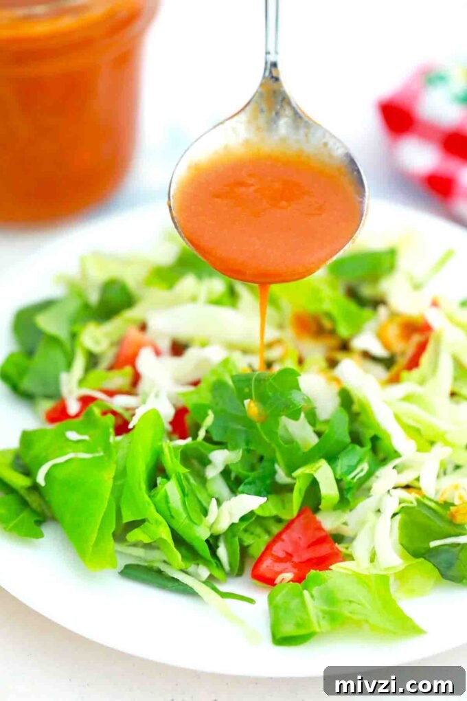 Homemade Catalina Salad Dressing in 5 Minutes 10 Drizzling Catalina dressing over a salad.