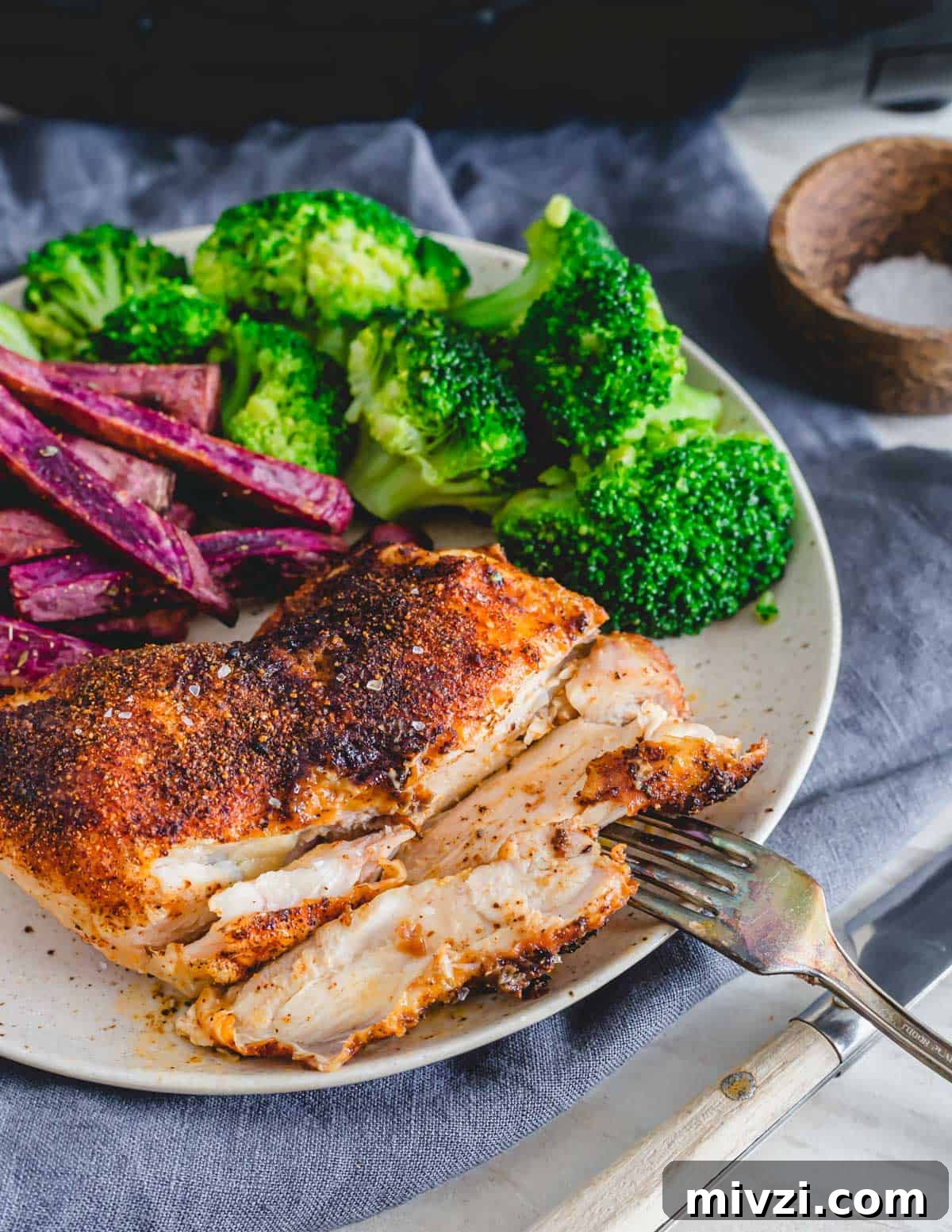 Sliced chicken leg quarters made in the air fryer on a plate with a fork. Sliced chicken leg quarters made in the air fryer on a plate with a fork.