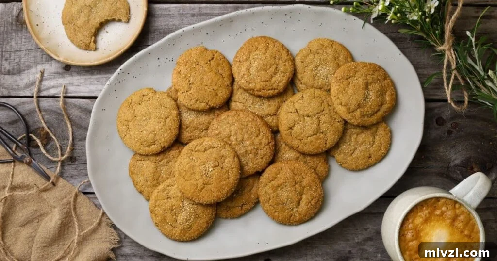 Sourdough Ginger Molasses Cookies with Spiced Chewy Texture 2 An oval platter filled with freshly baked sourdough ginger molasses cookies. There is also a cup of coffee in the photo.