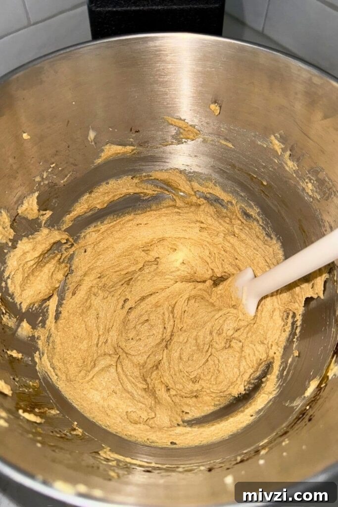 Sourdough Ginger Molasses Cookies with Spiced Chewy Texture 5 Creaming together butter and sugar in mixing bowl for sourdough ginger molasses cookies.