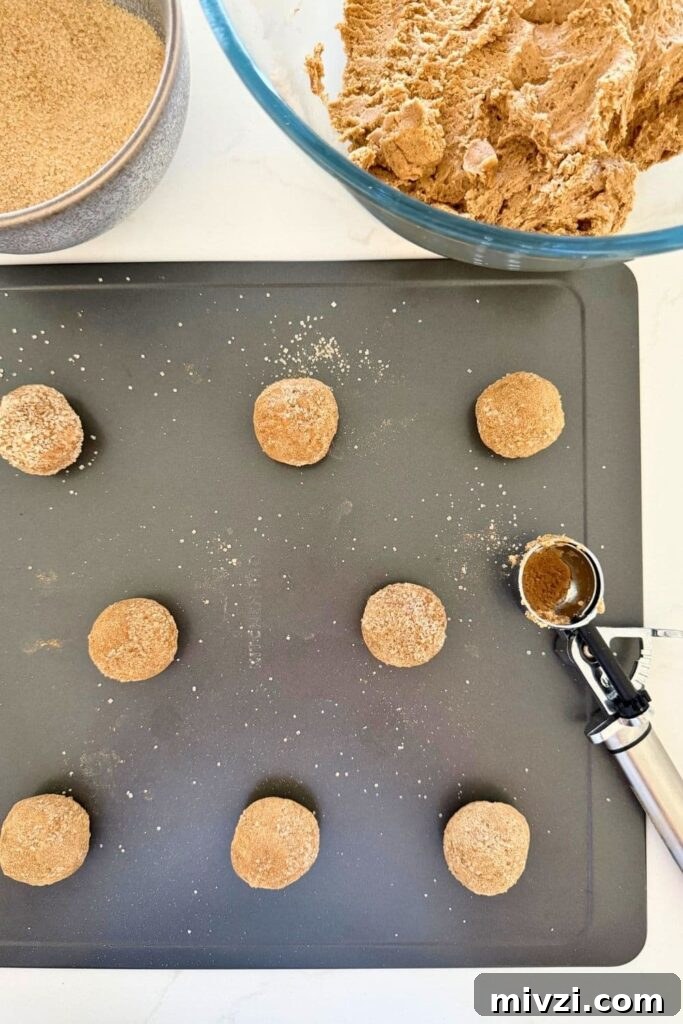 Sourdough Ginger Molasses Cookies with Spiced Chewy Texture 7 sourdough ginger molasses cookie dough being scooped onto cookie sheet.
