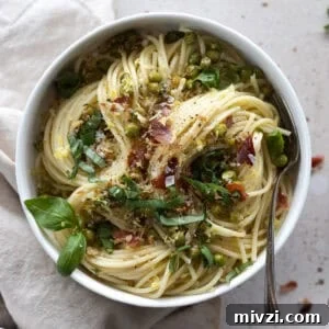 Pasta with Peas and Prosciutto in a white bowl.