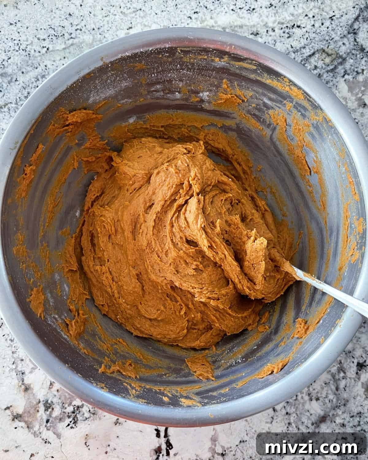 Pumpkin Spice Muffins Made from Cake Mix (Weight Watchers-Friendly) 5 Mixing spice cake mix and pumpkin puree in large mixing bowl with spoon.