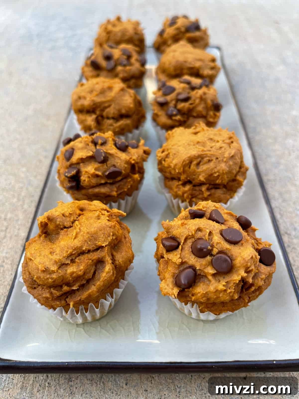 Pumpkin Spice Muffins Made from Cake Mix (Weight Watchers-Friendly) 9 Eight mini pumpkin spice cake mix muffins (half plain and half with miniature chocolate chips) on serving platter.
