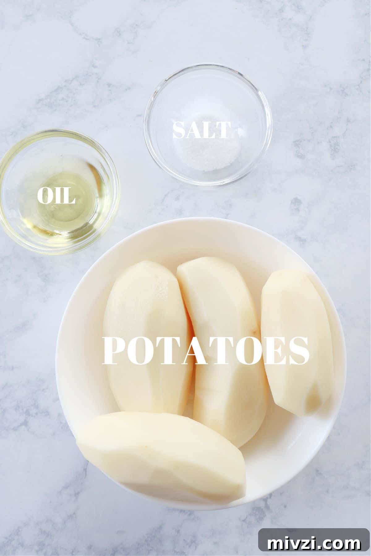 Ingredients for air fryer potato chips on marble board.