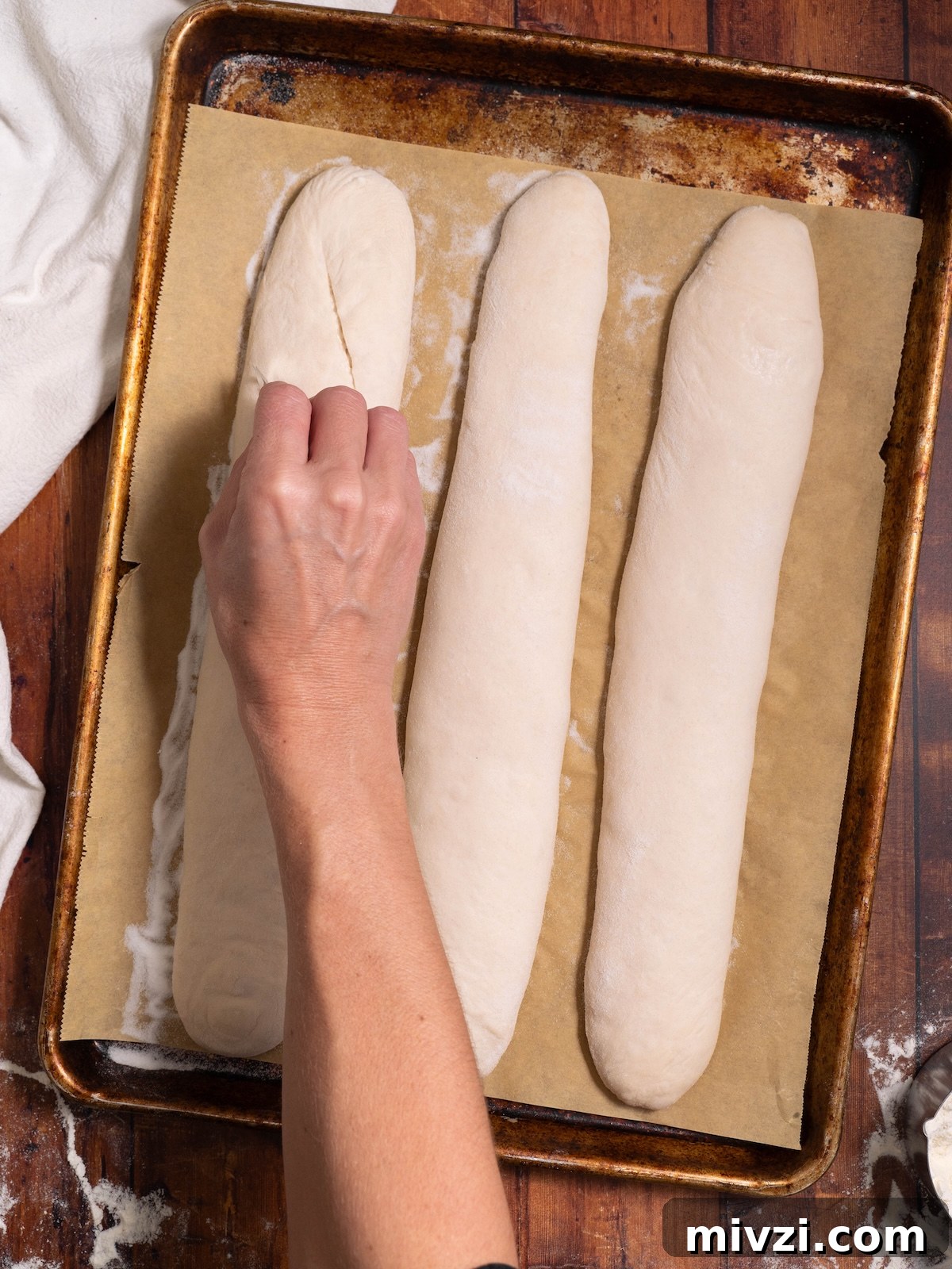 How to Make Classic Sourdough Baguettes at Home 12 Scoring baguettes with a sharp razor