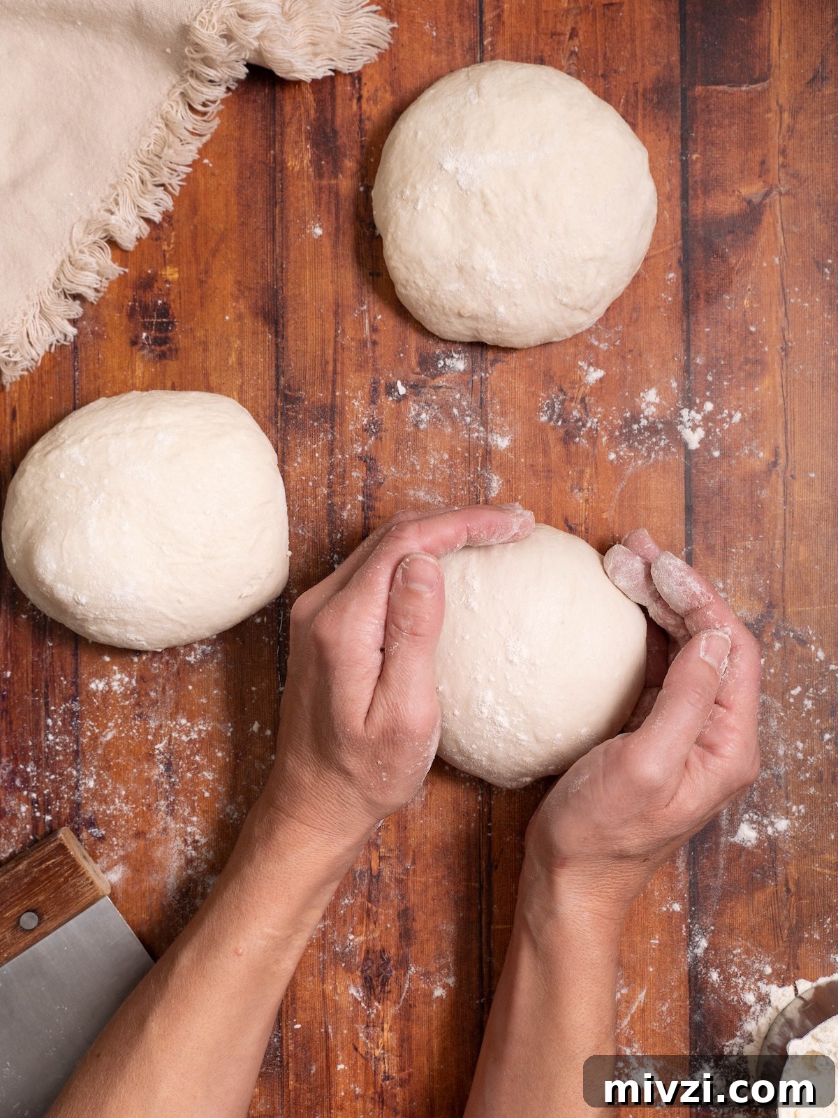How to Make Classic Sourdough Baguettes at Home 4 Rolling sourdough bread dough into a ball