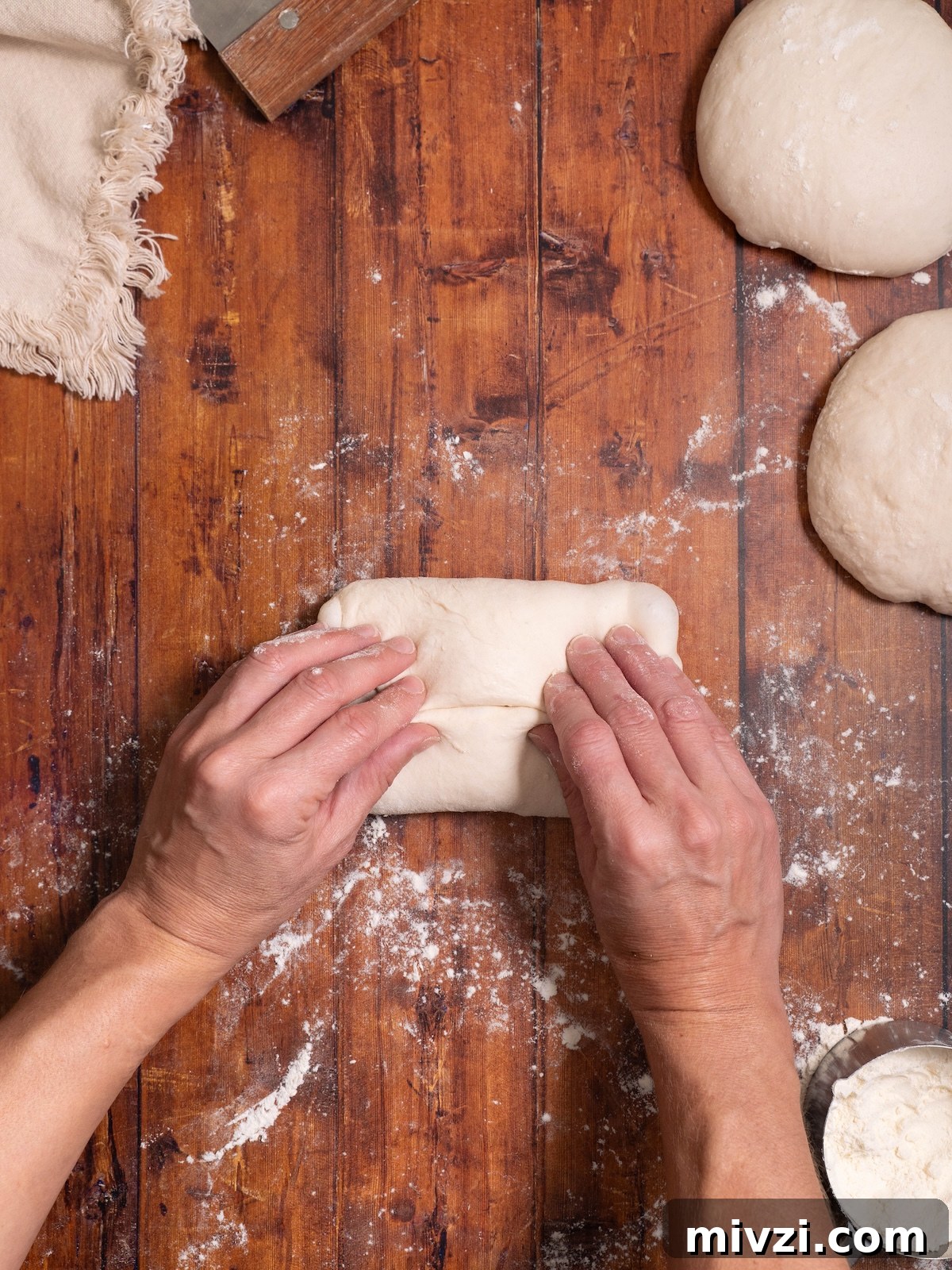 How to Make Classic Sourdough Baguettes at Home 7 Folding bread dough to shape into a baguette