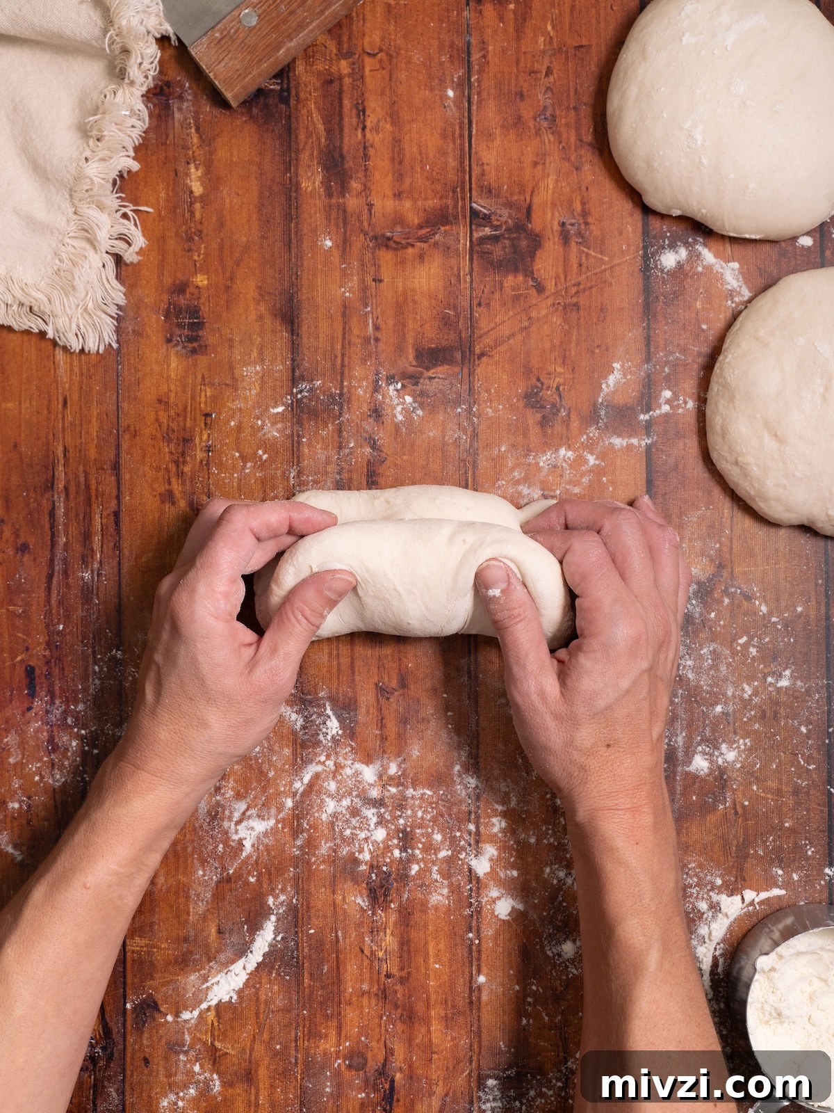 How to Make Classic Sourdough Baguettes at Home 8 Folding bread dough in half