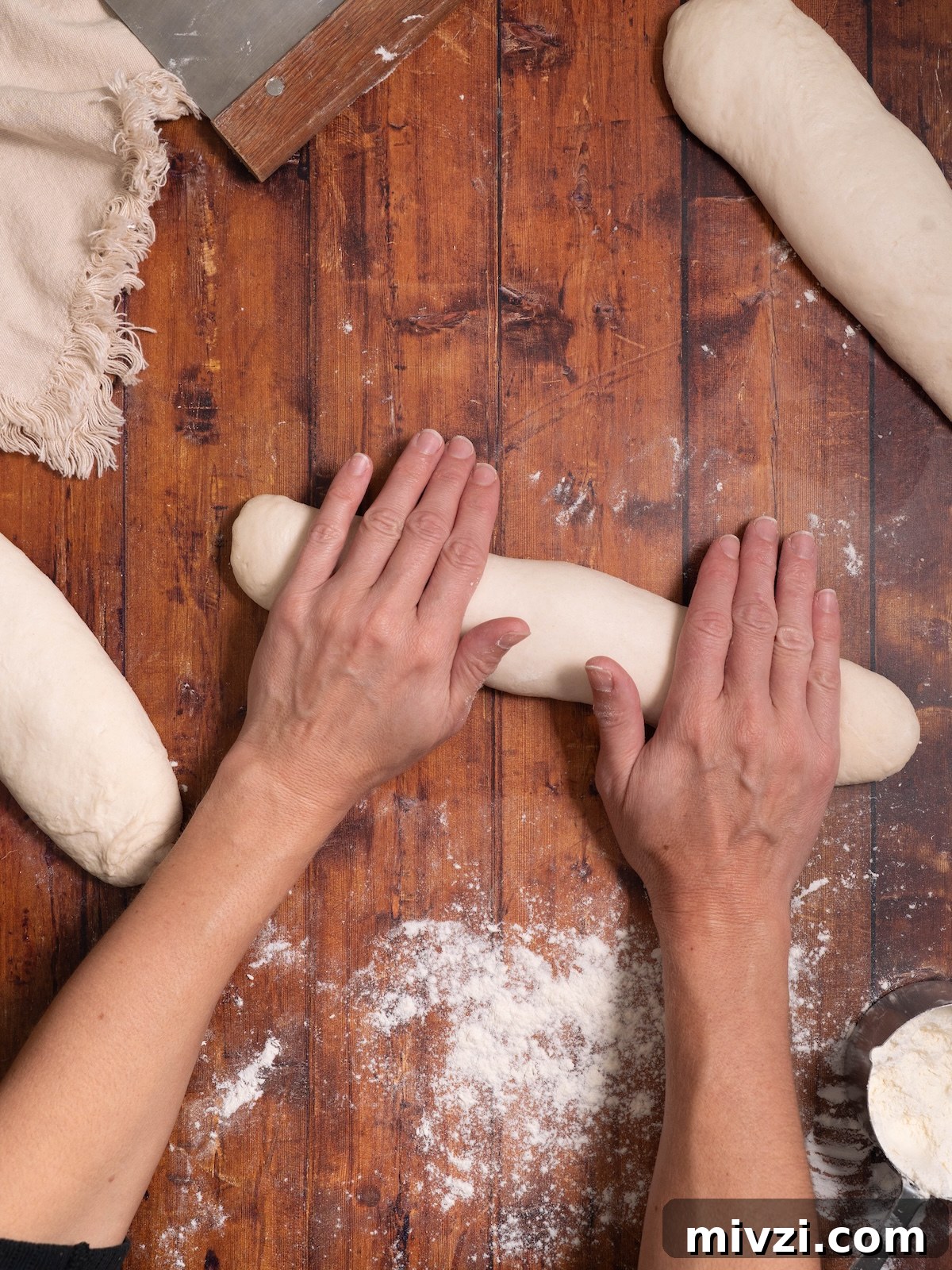 How to Make Classic Sourdough Baguettes at Home 9 Rolling bread dough into a cylinder