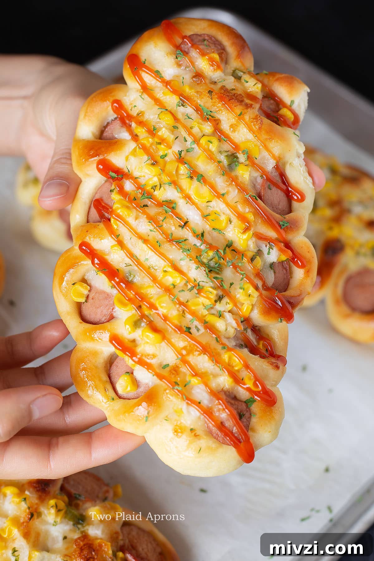 Korean sausage bread being held.