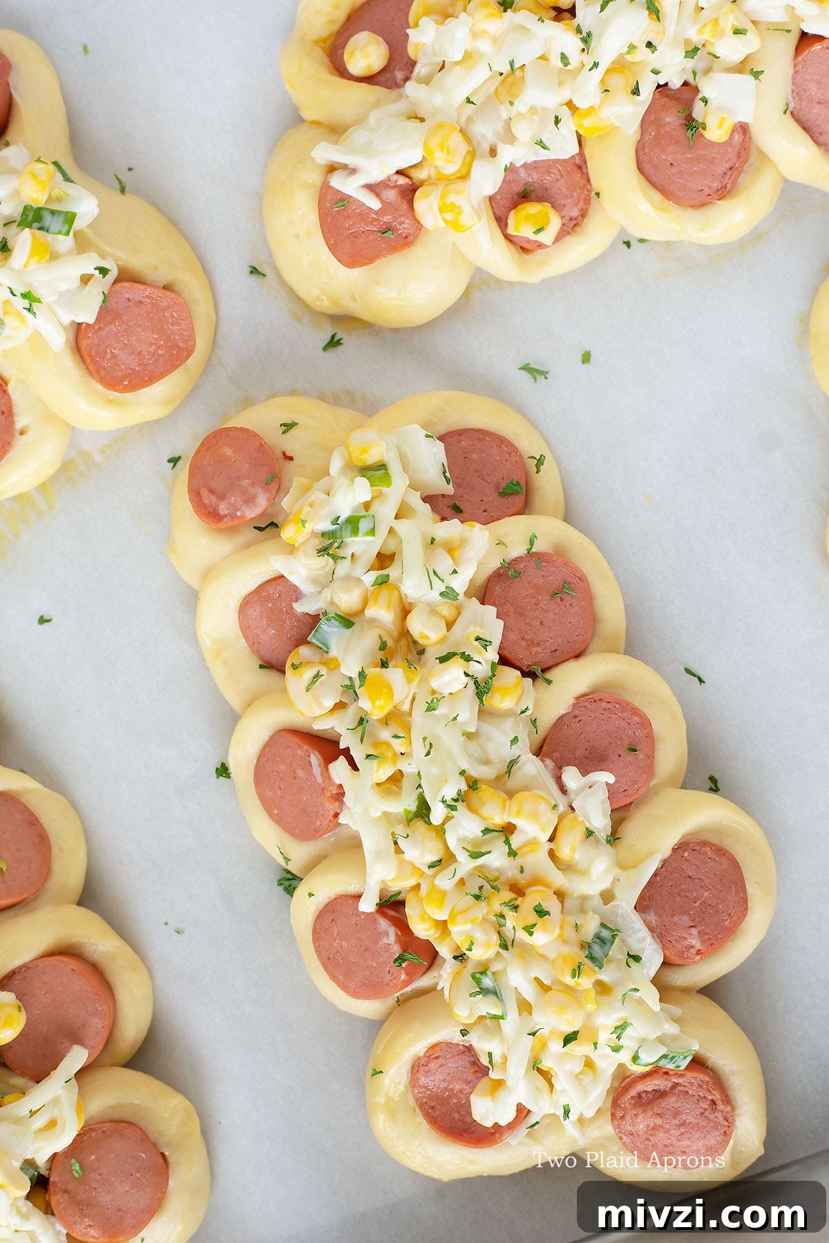 Corn and cheese mix on the middle on the uncooked bread.
