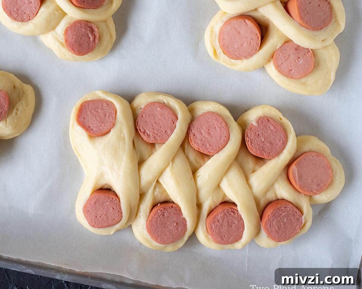 Unbaked sausage bread on the tray.