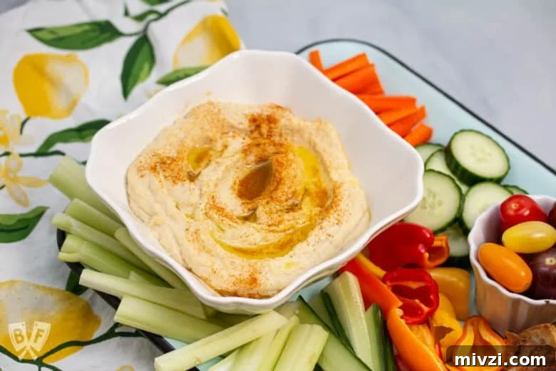Classic Hummus from Canned Chickpeas – Quick Authentic Recipe 2 Platter of hummus with fresh veggies and pita chips.