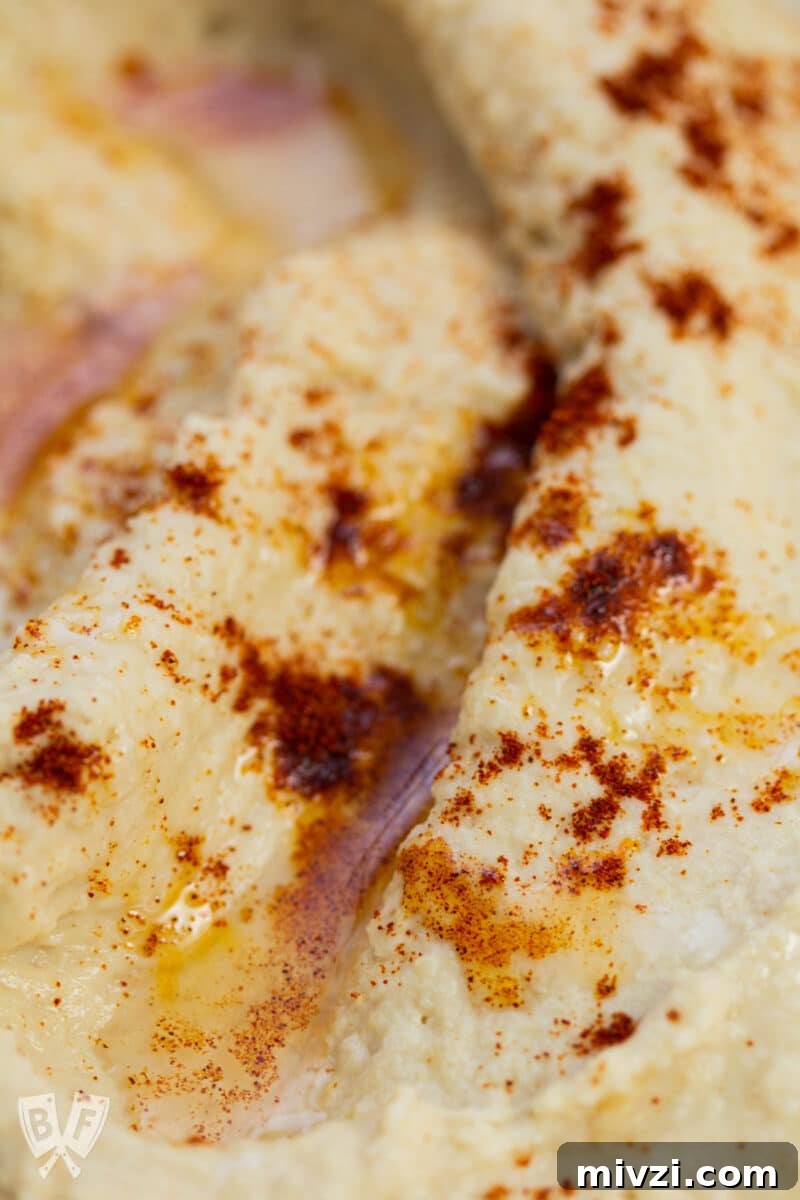 Classic Hummus from Canned Chickpeas – Quick Authentic Recipe 17 Close-up of hummus with paprika and olive oil.