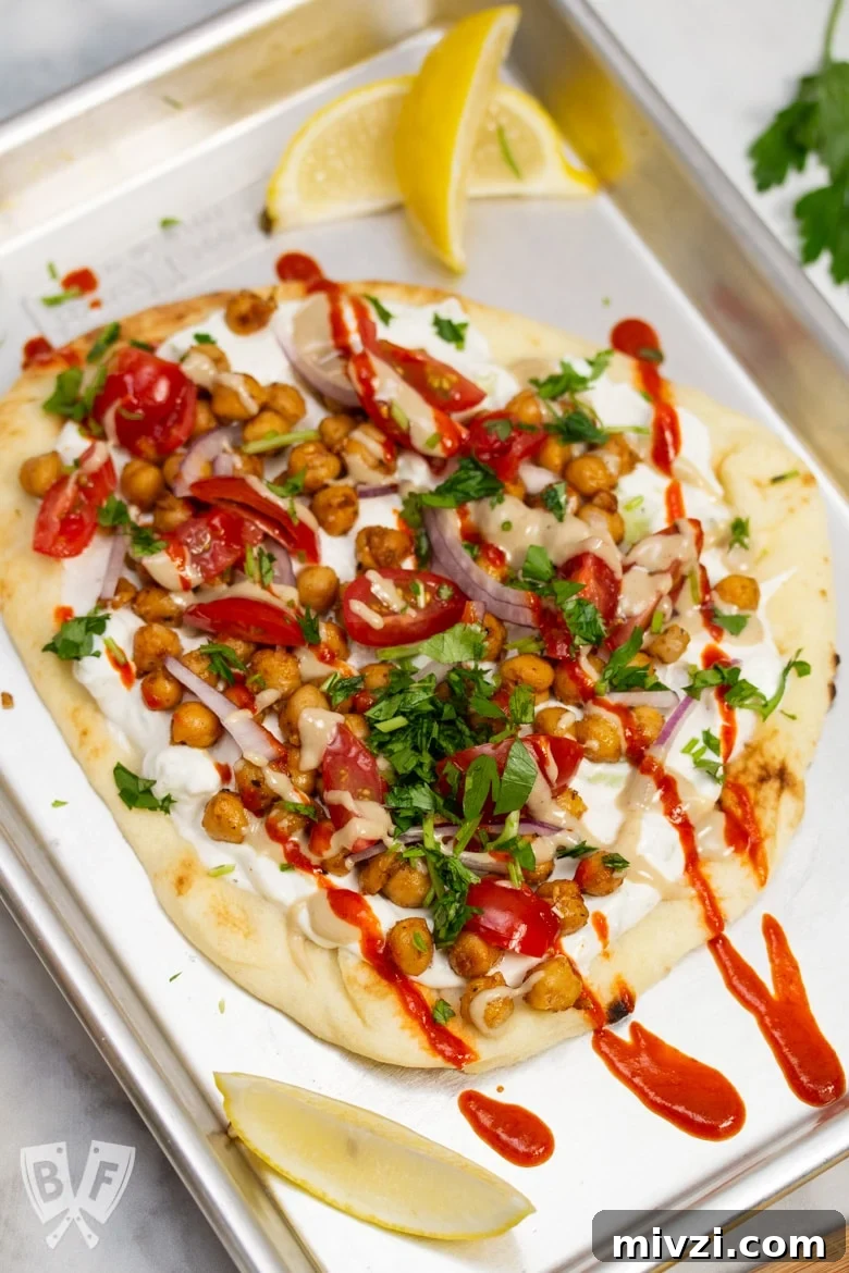 Classic Hummus from Canned Chickpeas – Quick Authentic Recipe 21 Overhead view of a sheet pan with Falafel-Spiced Chickpea Flatbread on top.