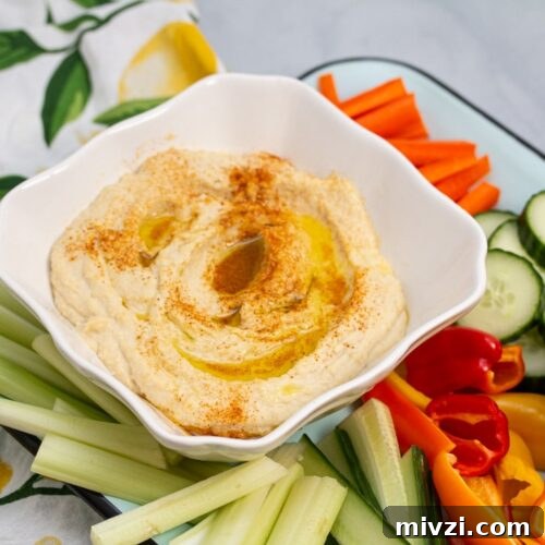 Classic Hummus from Canned Chickpeas – Quick Authentic Recipe 22 Platter of hummus with fresh veggies and pita chips.