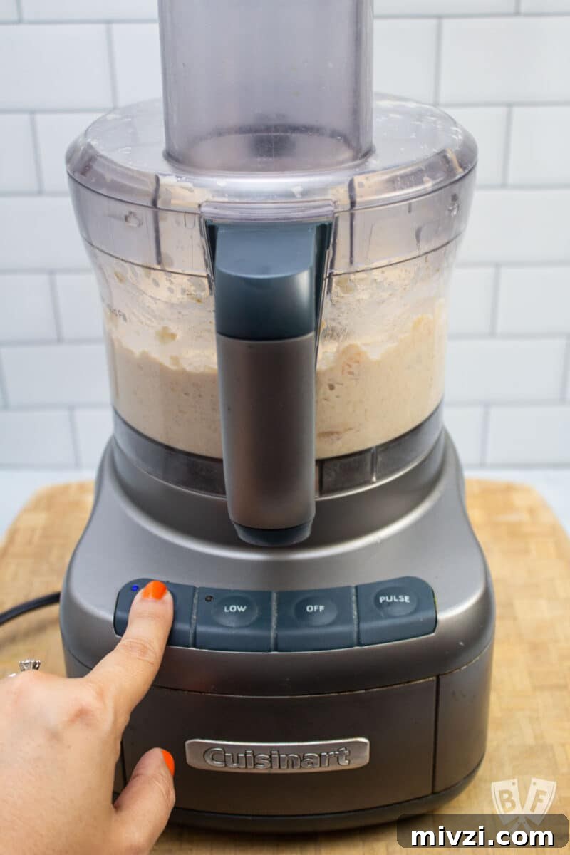 Classic Hummus from Canned Chickpeas – Quick Authentic Recipe 5 Hummus in a food processor on high speed.