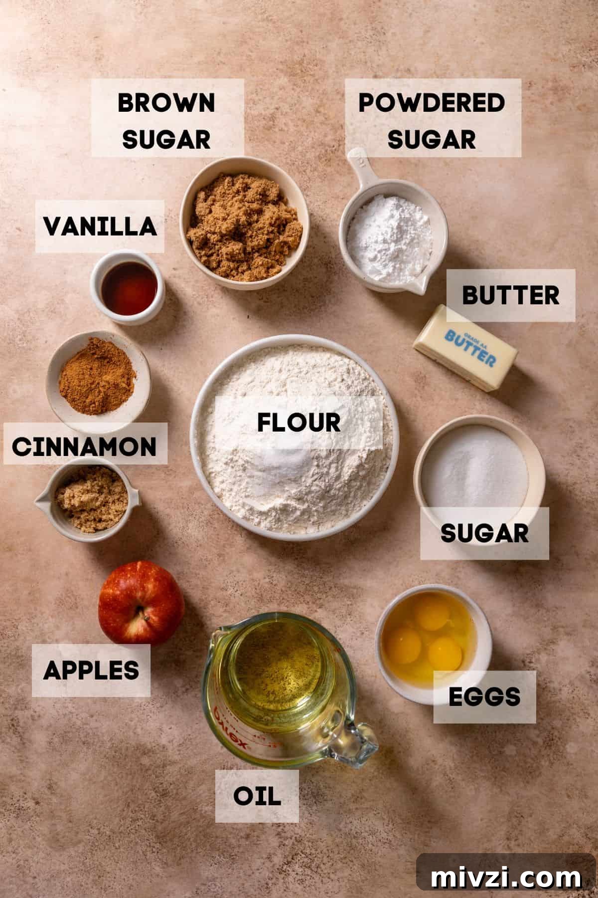 Ingredients needed to make apple cake in bowls with labels.