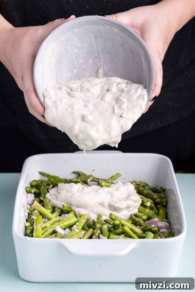 Cheesy Baked Asparagus Casserole Recipe with Crispy Top 13 Pouring cream of mushroom soup over asparagus, shallots, and garlic