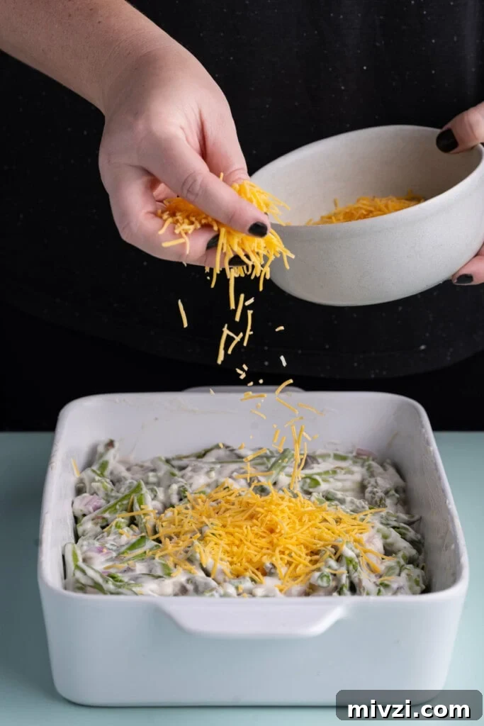 Cheesy Baked Asparagus Casserole Recipe with Crispy Top 14 Adding shredded cheddar cheese to asparagus casserole