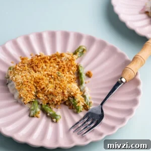 Cheesy Baked Asparagus Casserole Recipe with Crispy Top 18 Serving of Asparagus Casserole on a pink plate