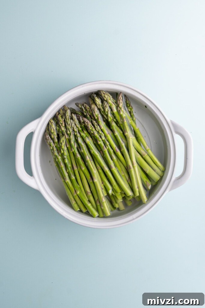 Cheesy Baked Asparagus Casserole Recipe with Crispy Top 4 Soaking asparagus in water to thoroughly clean it