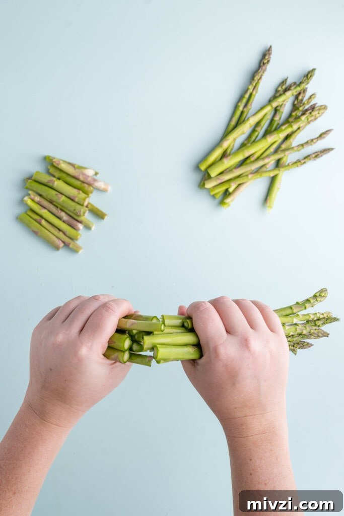 Cheesy Baked Asparagus Casserole Recipe with Crispy Top 5 Snapping woody ends off asparagus