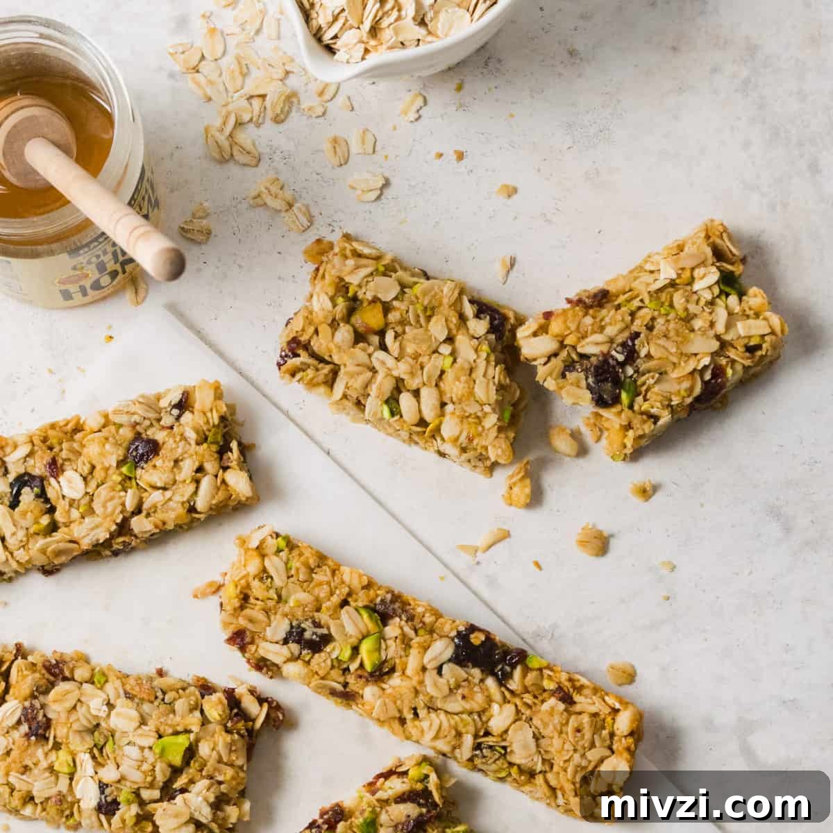 Gluten free granola bars scattered on a white table.
