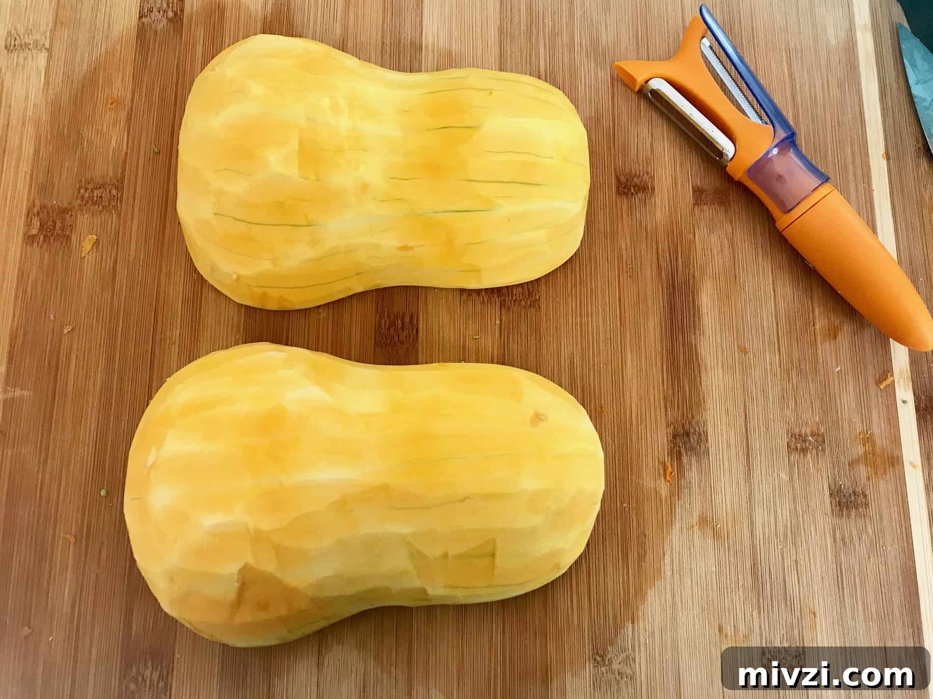 How to Cut a Butternut Squash Safely and Quickly 6 Butternut squash on cutting board cut in half with skin removed