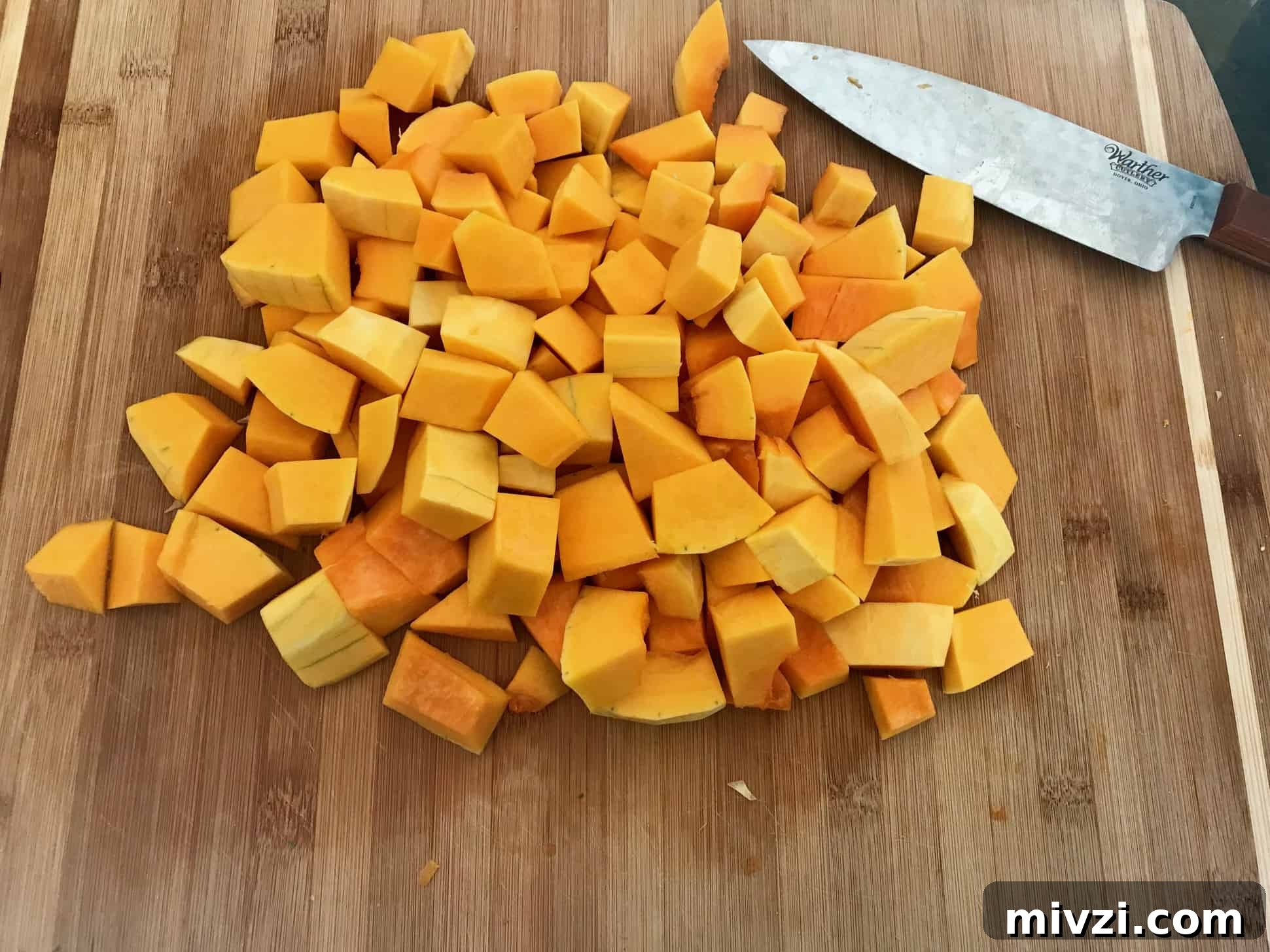 How to Cut a Butternut Squash Safely and Quickly 8 Butternut squash cubes in cutting board