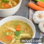 A bowl of food on a table, with Chicken and Soup