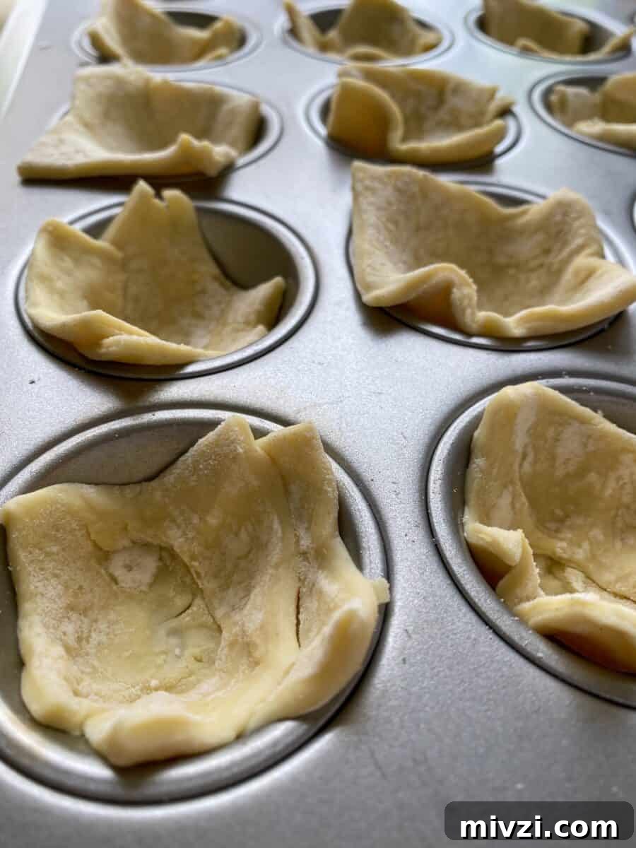 Mini Philly Cheesesteak Sliders: Bite-Sized Steak & Cheese Delight 6 Puffed pastry dough, raw, placed into mini-muffin cups.