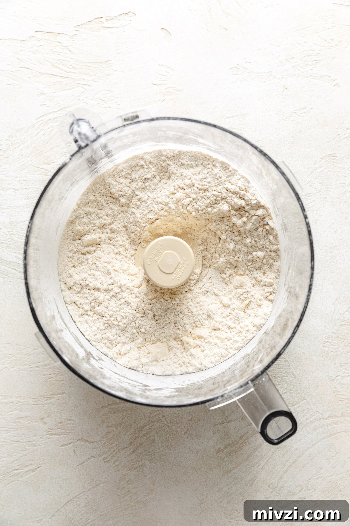 How to Make Perfectly Flaky Homemade Biscuits 5 Butter mixed with flour, baking powder, and salt.