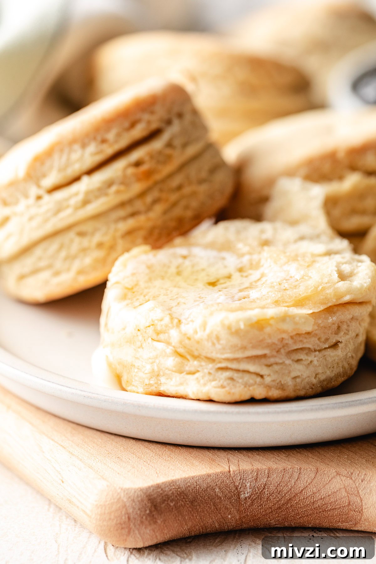 How to Make Perfectly Flaky Homemade Biscuits 8 Buttermilk biscuits on a plate.
