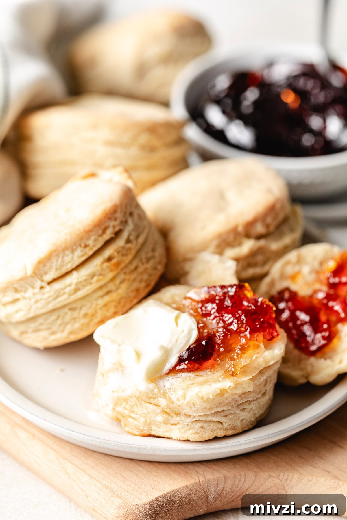 How to Make Perfectly Flaky Homemade Biscuits 9 Biscuits on a plate.