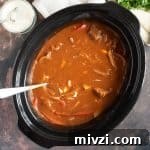 Hearty Slow Cooker Beef Goulash Recipe for Tender, Savory Meals 5 Slow cooker beef goulash in a black slow cooker basin.