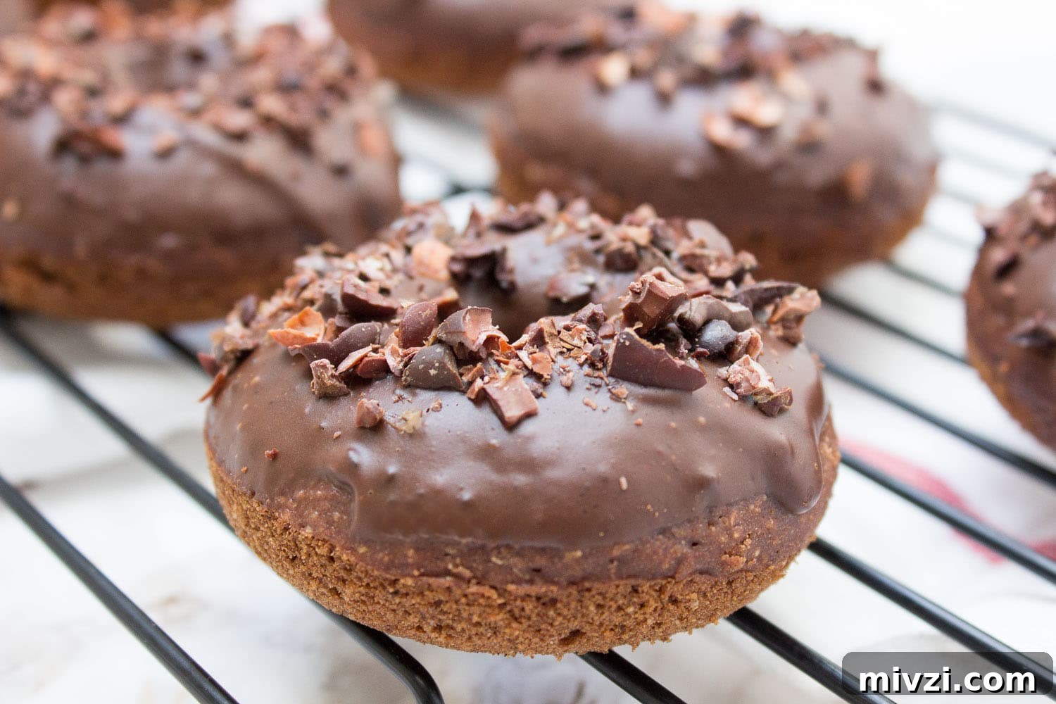 Double Chocolate Banana Donuts Recipe for Decadent Homemade Treats 3 Baked whole wheat double chocolate banana donuts infused with cinnamon and topped with melted dark chocolate. These are made with all healthy ingredients, nutritious and contains no refined sugars! CLICK to read more or PIN for later! #donuts #doughnuts #healthy #easy