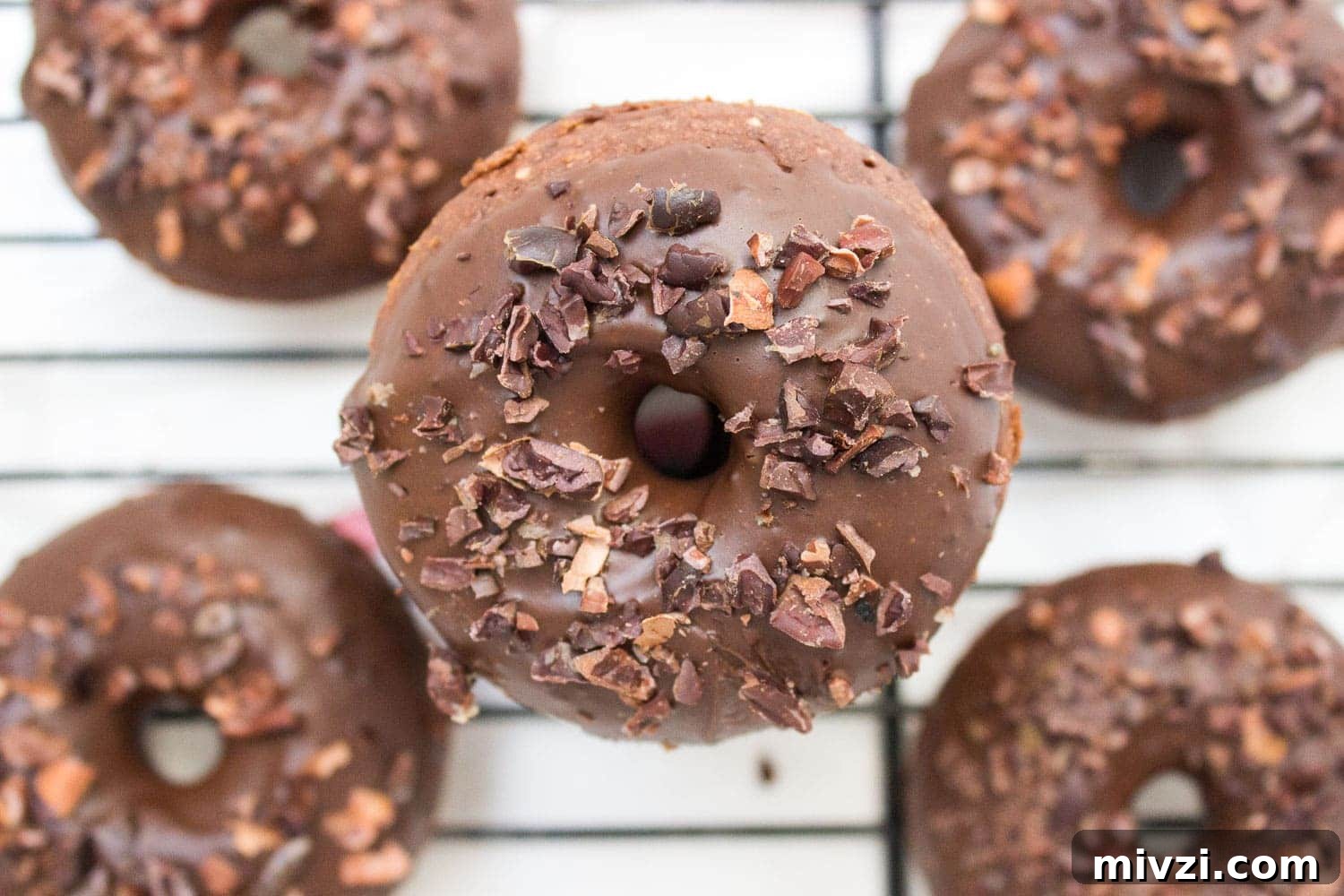 Double Chocolate Banana Donuts Recipe for Decadent Homemade Treats 4 Baked whole wheat double chocolate banana donuts infused with cinnamon and topped with melted dark chocolate. These are made with all healthy ingredients, nutritious and contains no refined sugars! CLICK to read more or PIN for later! #donuts #doughnuts #healthy #easy