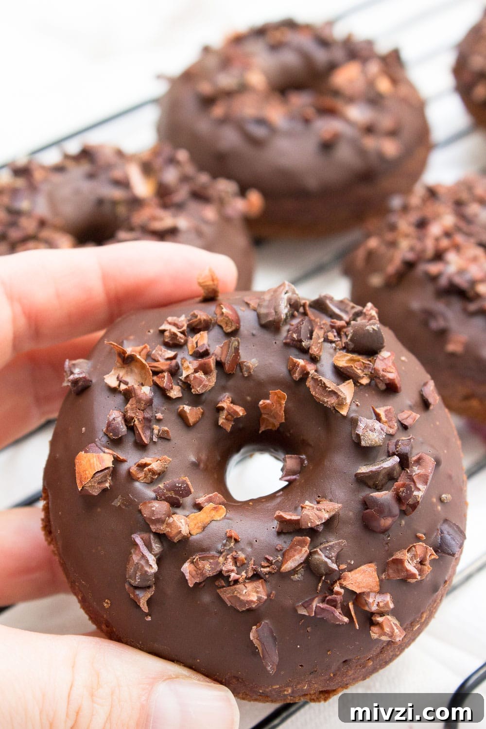 Double Chocolate Banana Donuts Recipe for Decadent Homemade Treats 5 Baked whole wheat double chocolate banana donuts infused with cinnamon and topped with melted dark chocolate. These are made with all healthy ingredients, nutritious and contains no refined sugars! CLICK to read more or PIN for later! #donuts #doughnuts #healthy #easy