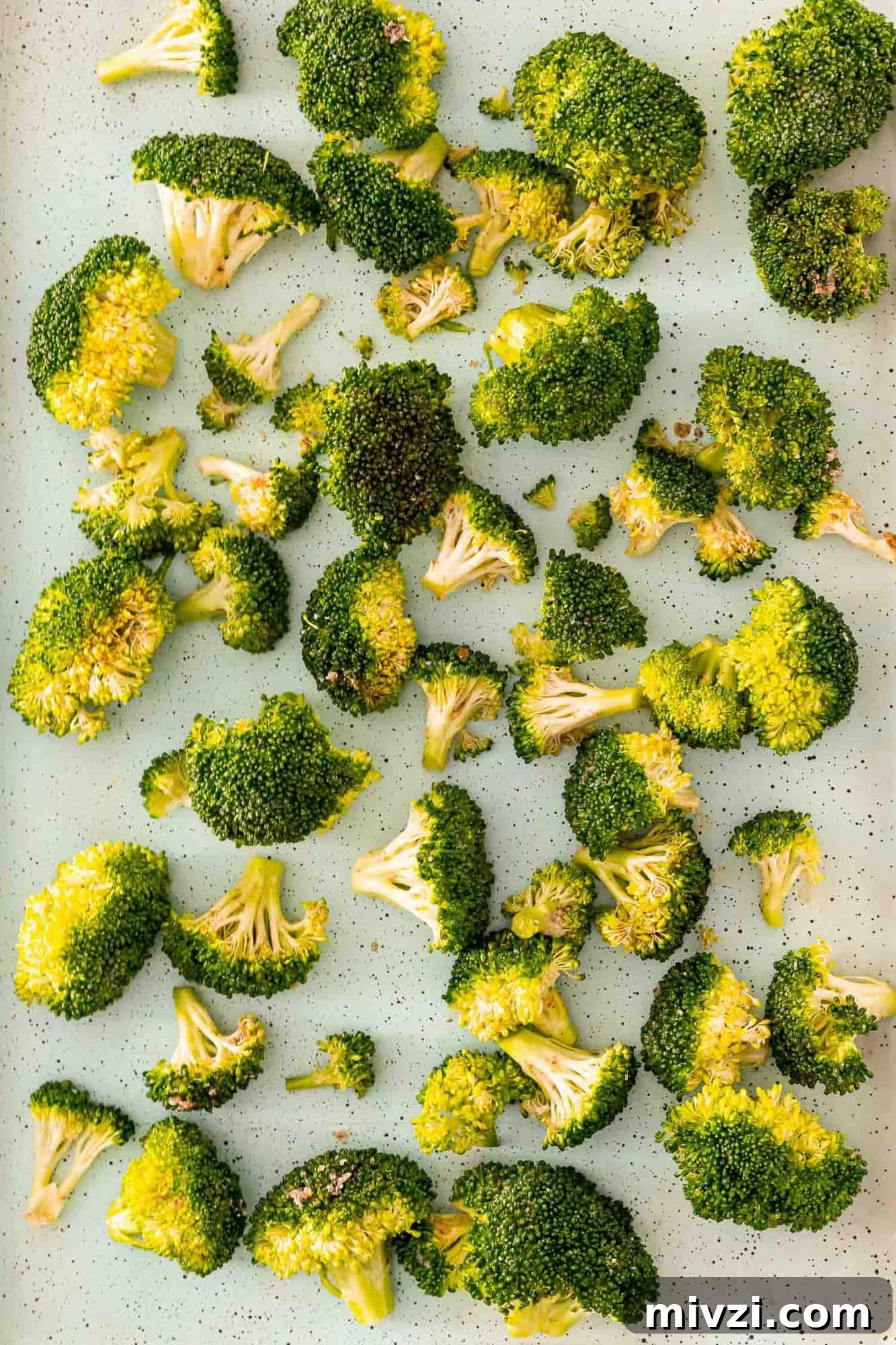 Uncooked broccoli on a sheet pan.