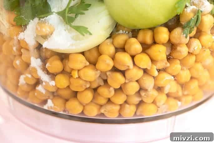 Soaked chickpeas onions and herbs in food processor