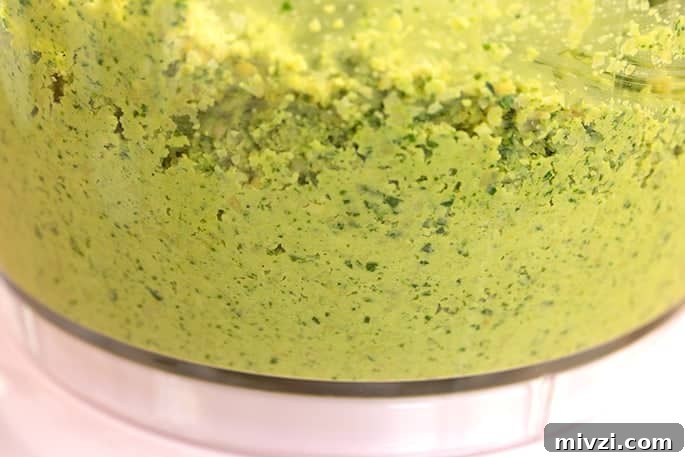 Raw falafel mixture in food processor bowl