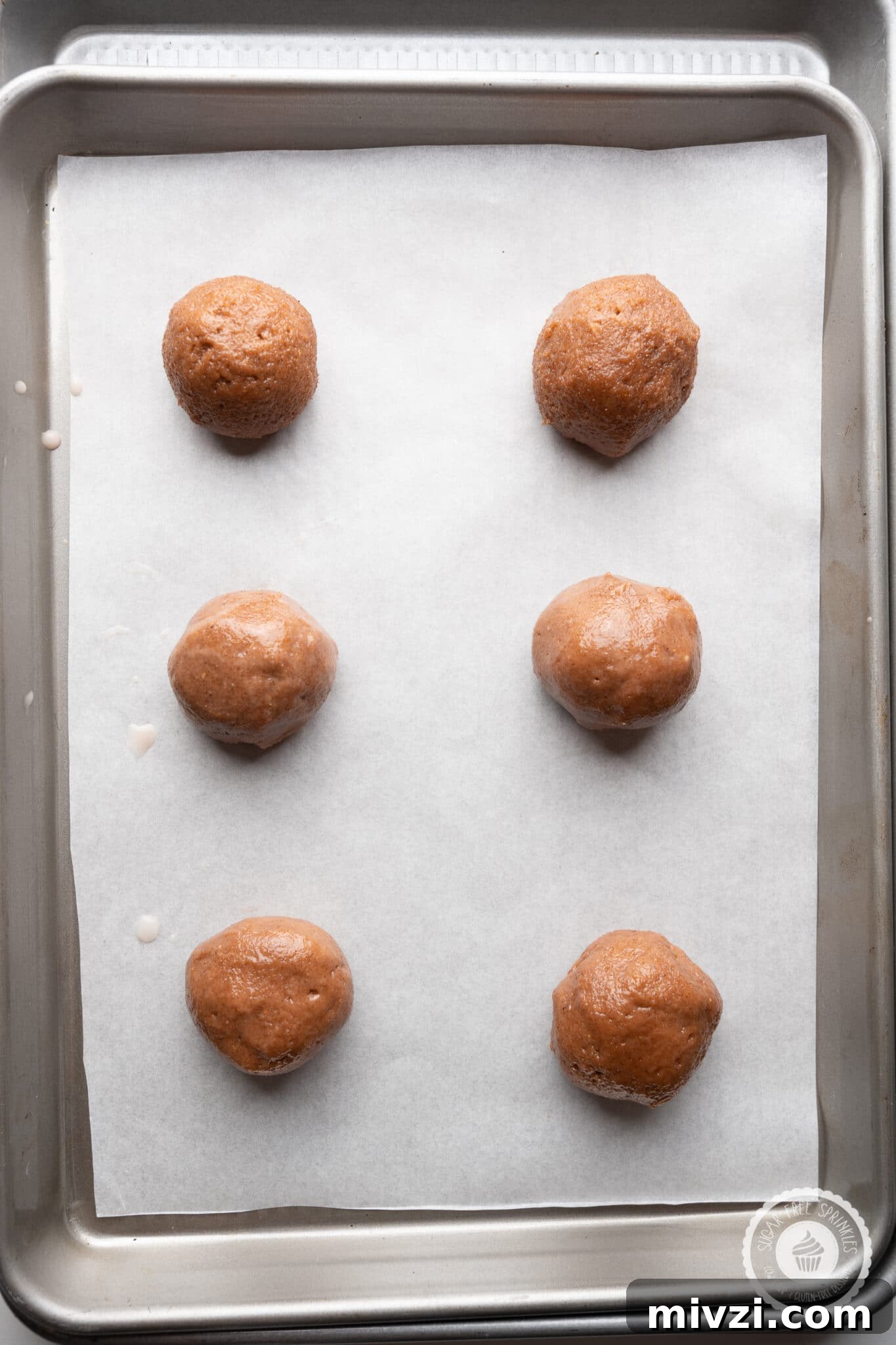 Soft Keto Gingerbread Cookies: Chewy Low-Carb Holiday Treat 10 Cookie dough balls spread evenly on a doubled cookie sheet.