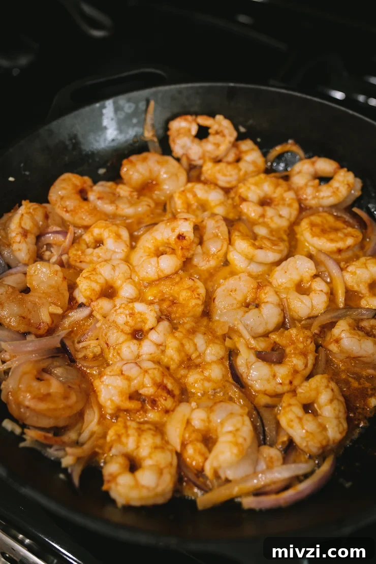 Garlic Shrimp Mexican-Style: Mojo de Ajo Camarones Recipe 7 buttery Camarones al Mojo de Ajo cooking in the skillet.