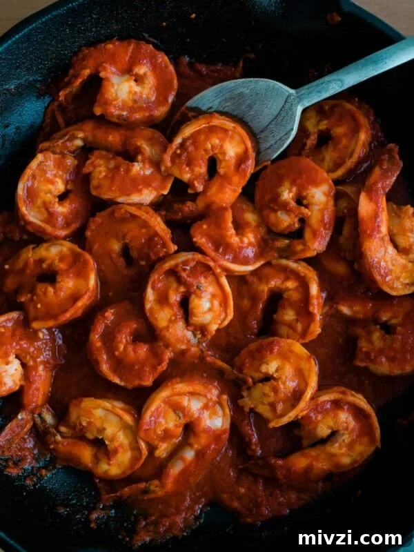 Garlic Shrimp Mexican-Style: Mojo de Ajo Camarones Recipe 9 Camarones a la Diabla recipe simmering in a cast iron skillet with smoky red guajillo and chile de árbol sauce.