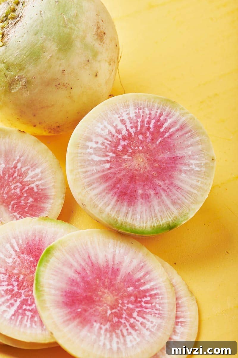 Watermelon Radish: Taste, Uses, and How to Cook It 2 Cut watermelon radish on yellow table.