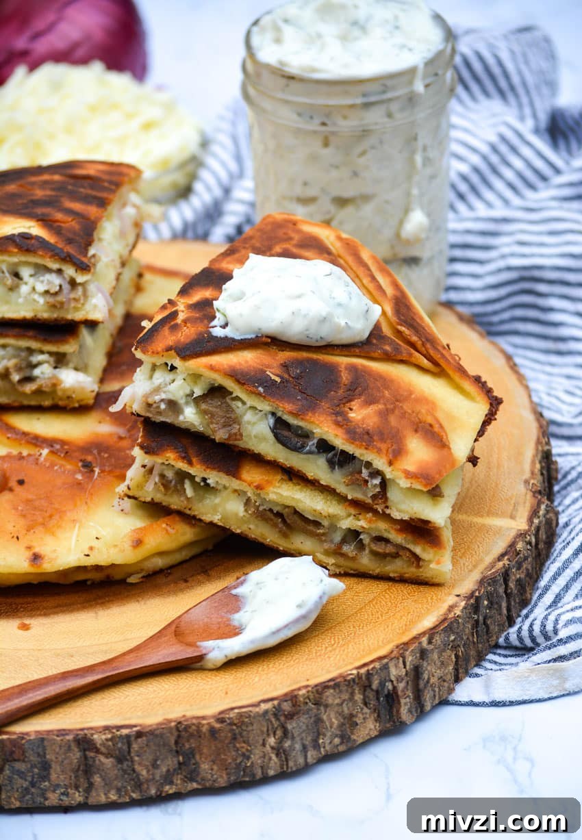 slices of greek gyro quesadillas on a wooden cutting board